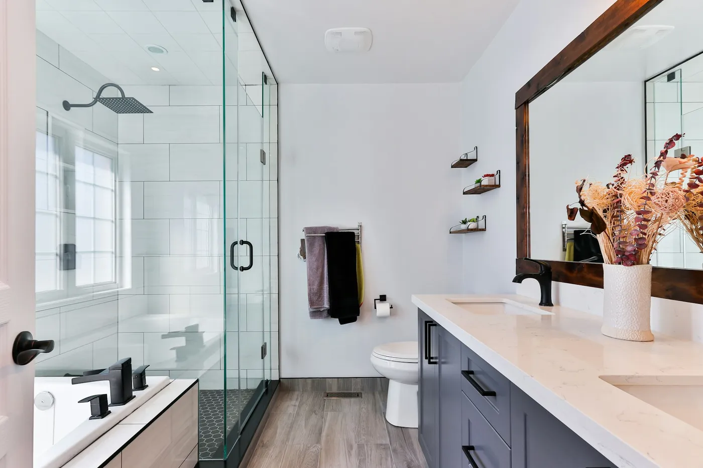 Modern bathroom with glass shower and wood vanity