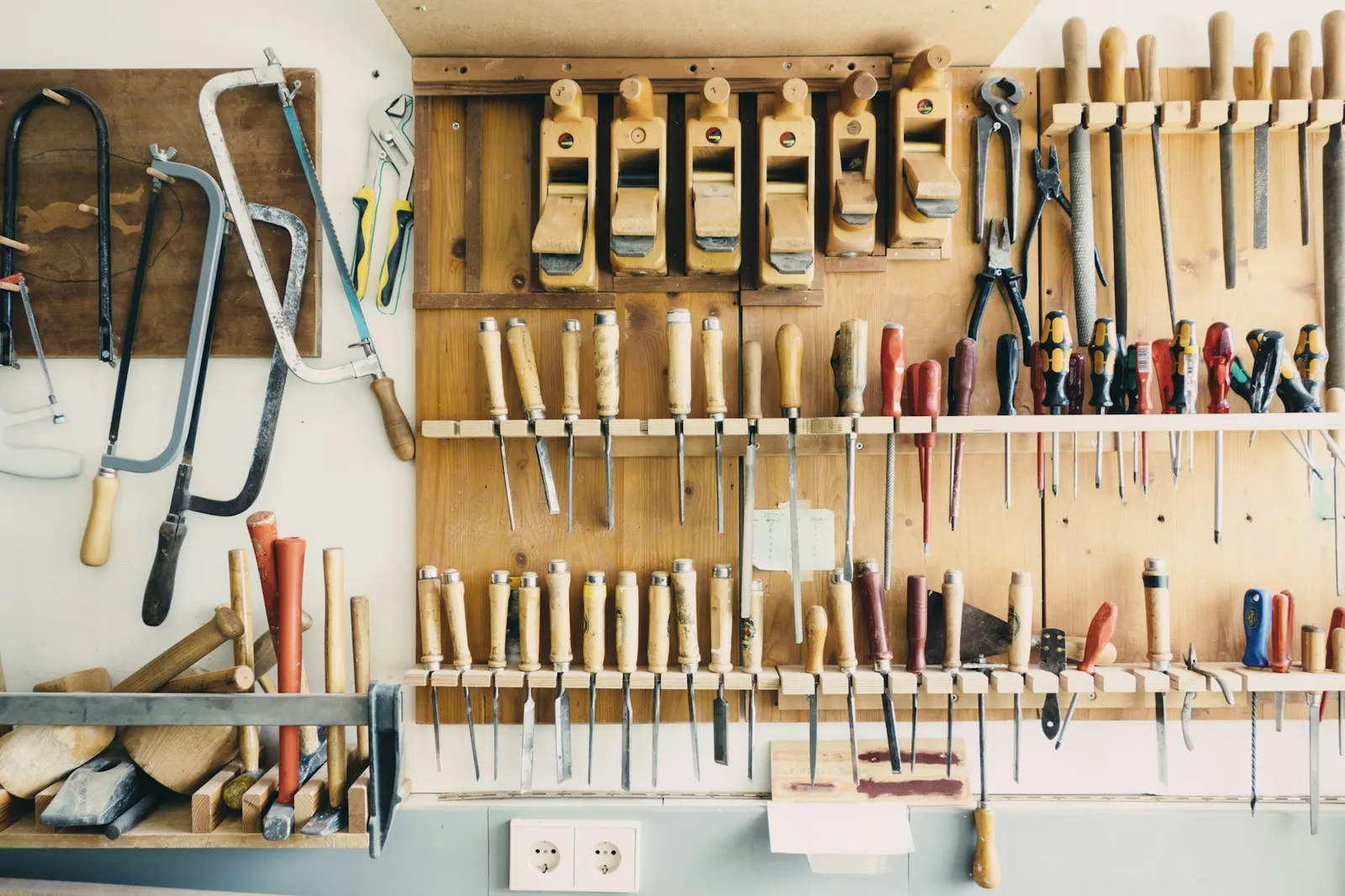 Wall of hand tools neatly organized in a workshop